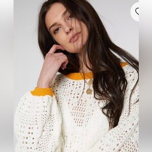 Free People  Home Run Sweater.  Ivory knit sweater with orange trim.